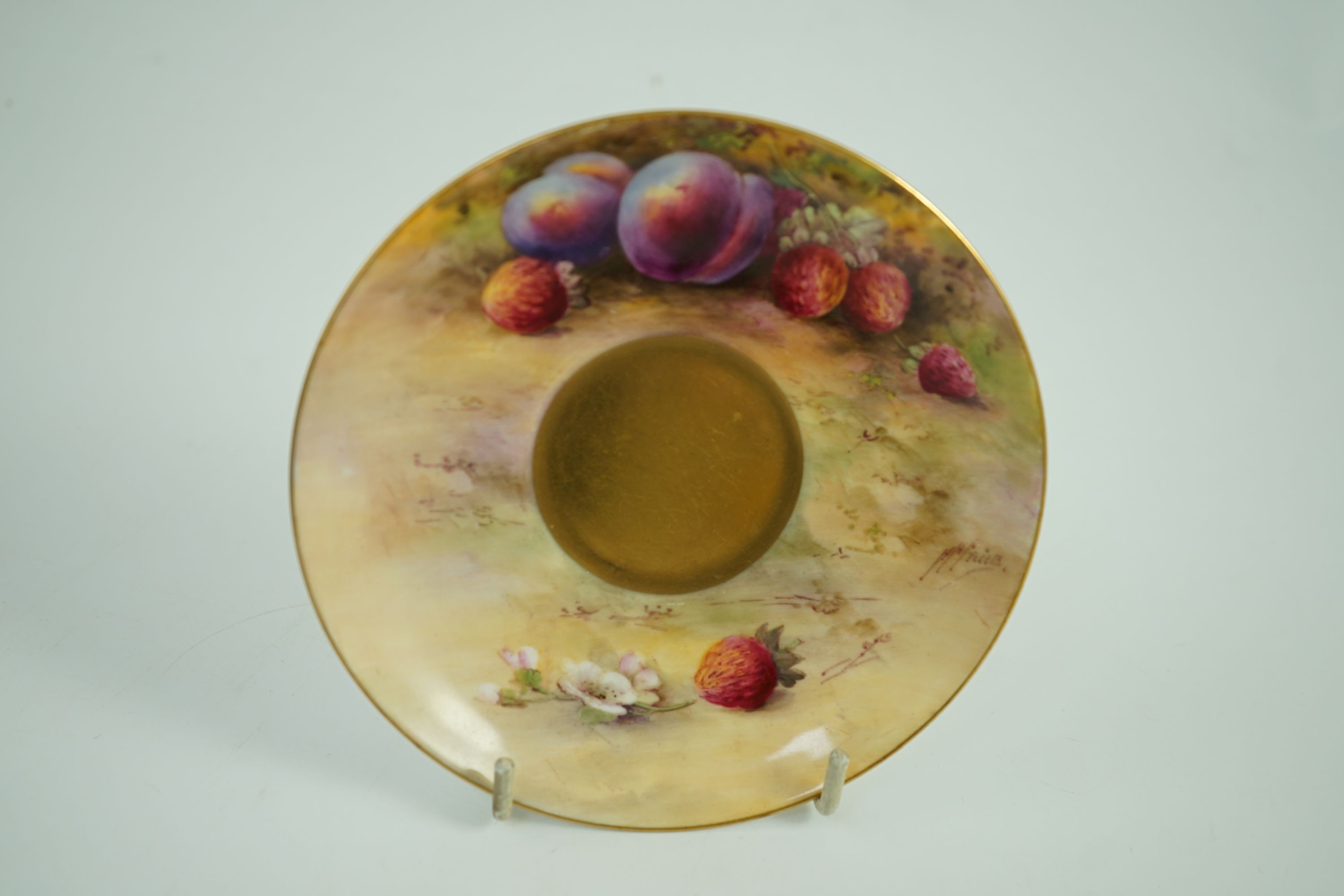 A Royal Worcester fruit painted tea cup and saucer, date code for 1925/6